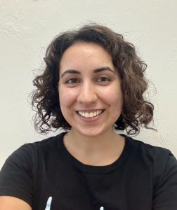 Julie smiles for the camera wearing a black short-sleeved shirt, picky eating | Food Science and Human Nutrition UF/IFAS