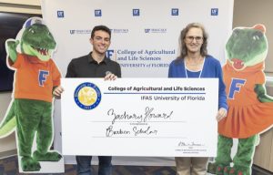Zachary and Dr. Elaine Turner standing with a large check as Zachary is honored as a Barben Scholar with the University of Florida College of Agriculture and Life Sciences | Food Science and Human Nutrition UF/IFAS