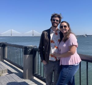 Melissa and friend standing on a pier overlooking the water.