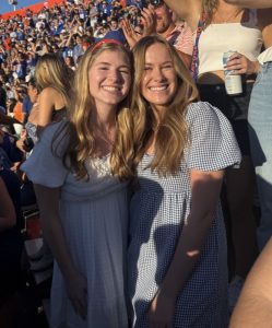 Julia and her friend in the middle of a large crowd.