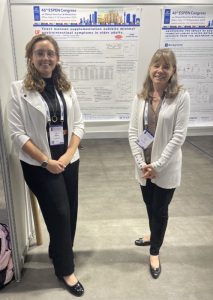 Melissa and her mentor, Dr. Wendy Dahl, wearing white blazers and standing in front of a research poster, facial pain | Food Science and Human Nutrition UF/IFAS