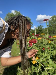 Rachel smelling a flower.