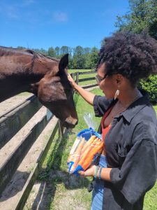 Rachel petting a horse.