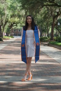 Ashley outside wearing a white dress and graduation sash, children with ARFID | Food Science and Human Nutrition UF/IFAS