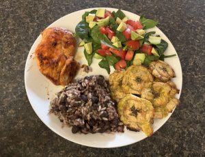 A white plate with rice, chicken, salad, and baked tostones, Hispanic food | Food Science and Human Nutrition UF/IFAS