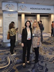 Fr. Farzad and a student standing in front of conference sign.