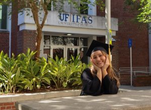 Evelyn in graduation gear outside a UF/IFAS building, opportunity | Food Science and Human Nutrition UF/IFAS