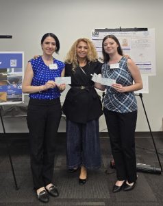 Dr. Farzad with two graduate students holding checks.