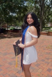 Kamille standing in front of trees, budget | Food Science and Human Nutrition UF/IFAS