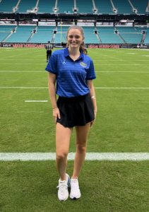 Rileigh standing in a sports stadium wearing a blue shirt and black shorts, gut health | Food Science and Human Nutrition UF/IFAS