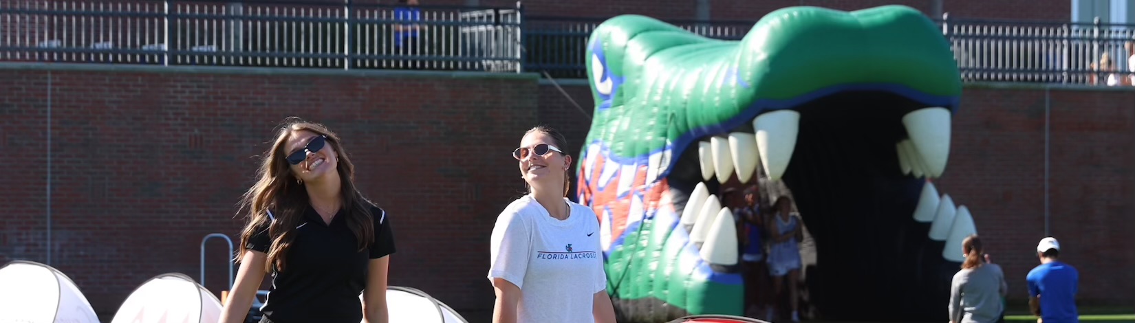 Julia and friend outside in front of a crocodile statue