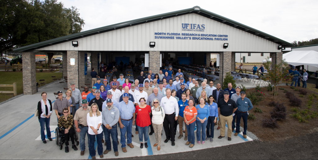 A smiling group of people outside the pavilion.