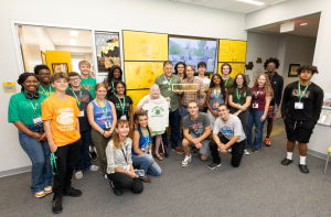 Group of students faculty and supporters at the Damron Family Office dedication. They are at the Honey Bee Research and Extension Laboratory lobby.