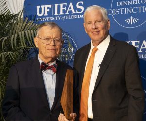 Erny Sellers accepts award from Scott Angle on stage at Dinner of Distinction