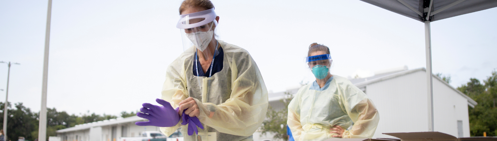 Nurse putting on safety PPE at a Covid-19 mobile testing site. Photo taken 07-10-20.