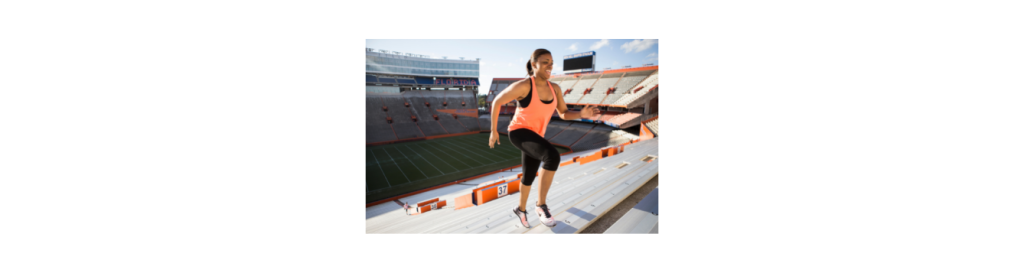 Woman running up stadium steps