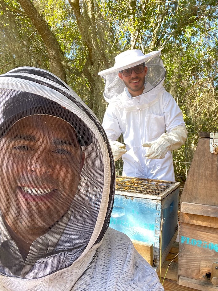 Luis Rodriguez and Jonael Bosques inspecting bees and creating educational videos