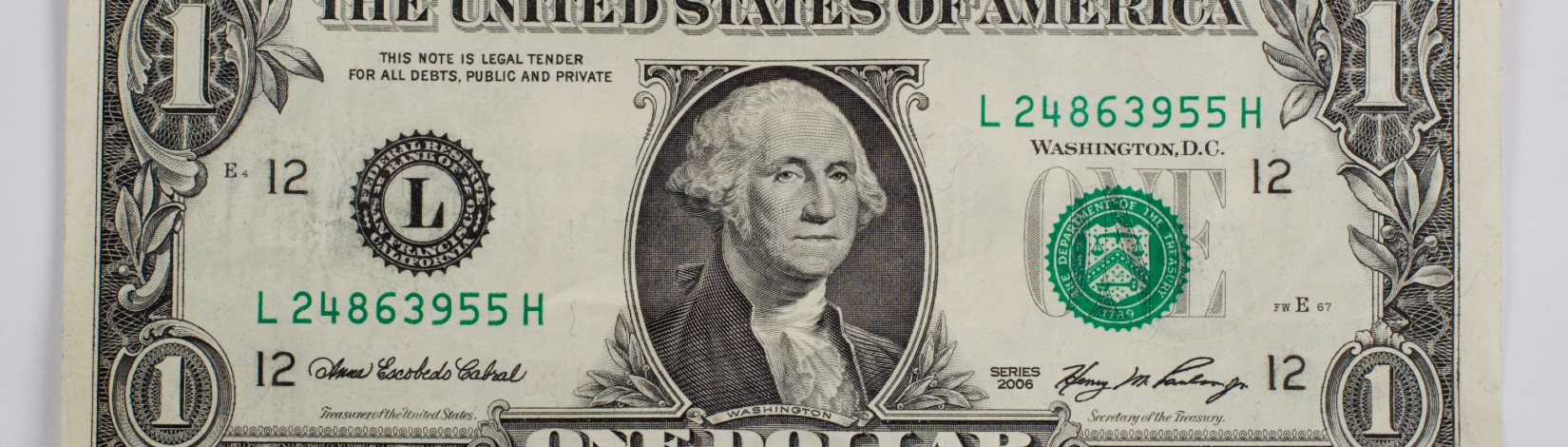 A single one dollar bill. Money, cash, currency.