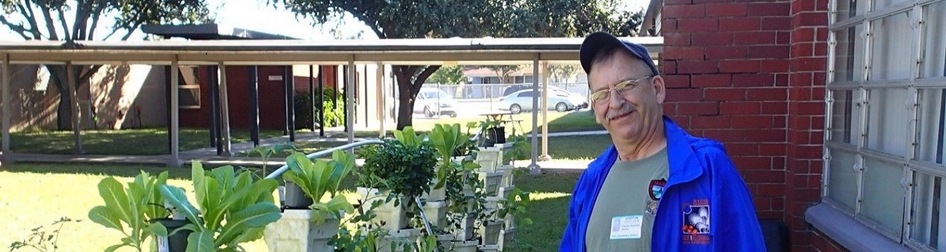 Master Gardener volunteer Charlie Reynolds Stand by Vegetables growing at Avon Park Elementary school.
