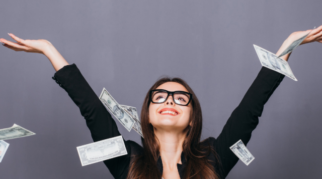 Woman with laptop and money flying