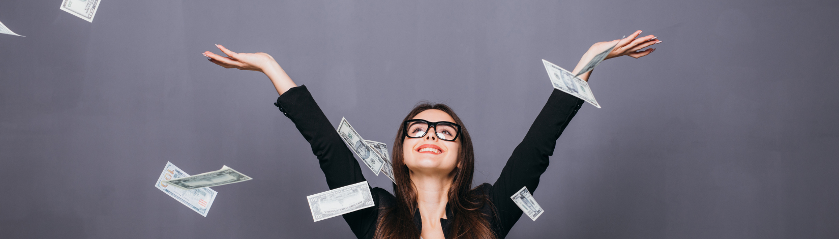 Woman with laptop and money flying