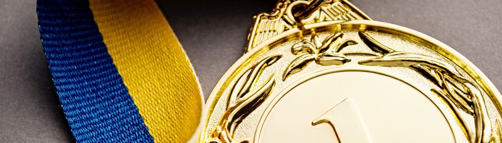 Gold medal on a dark blue background.