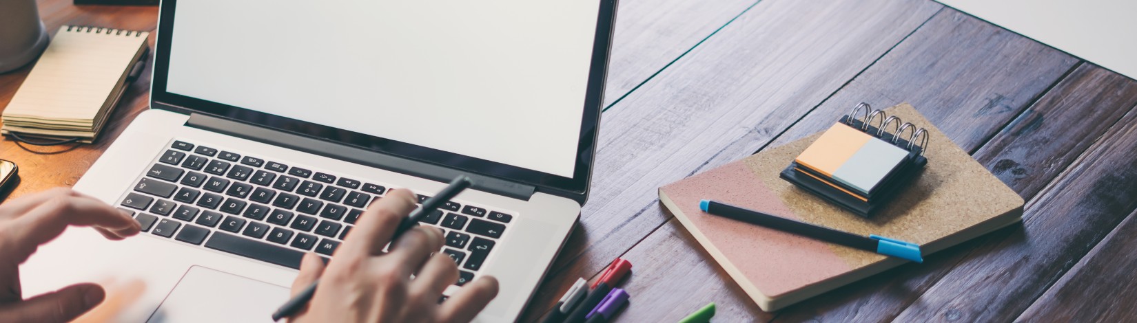 Close up of male hands and laptop with blank screen. Mock-up of computer monitor. Copyspace ready for design or text.