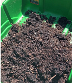 turned compost in bin