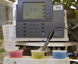 A pH testing machine at the UF Soils Testing Lab showing the 3 buffering solutions for acid, neutral, and alkaline calibration.