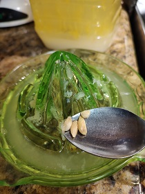 Removing seeds from the lemon juice in the citrus-reamer.