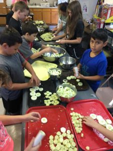 4-H members making spiced apple rings out of cucumbers