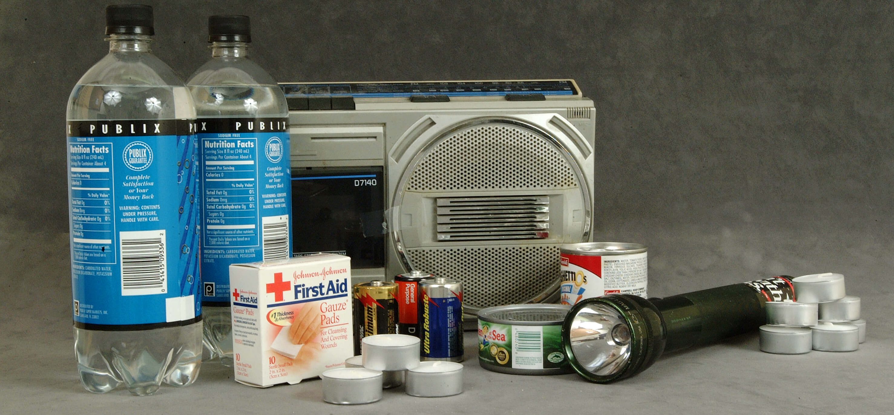 This is an example of the items to keep in a hurricane preparedness kit for disaster planning - radio, water, medicines, flashlight, batteries, canned food