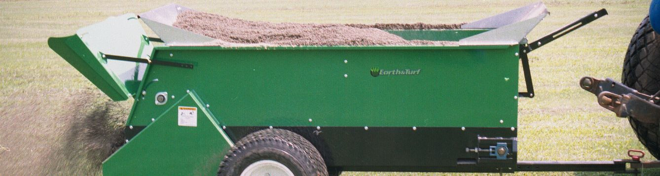 A mechanical topdresser has a hopper full of screened compost product ready to apply to turfgrass.