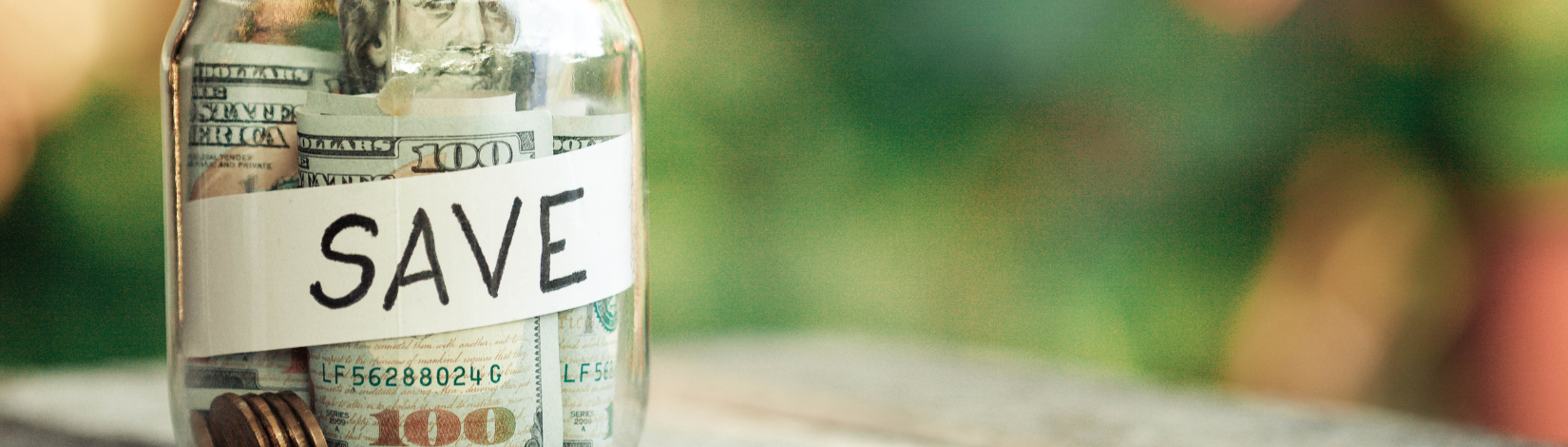 Glass jars with dollars and text save.
