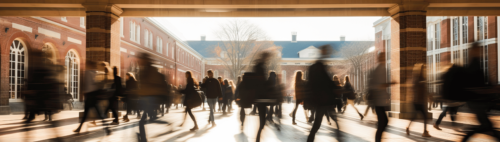 Crowd of students walking through a college campus on a sunny day, motion blur