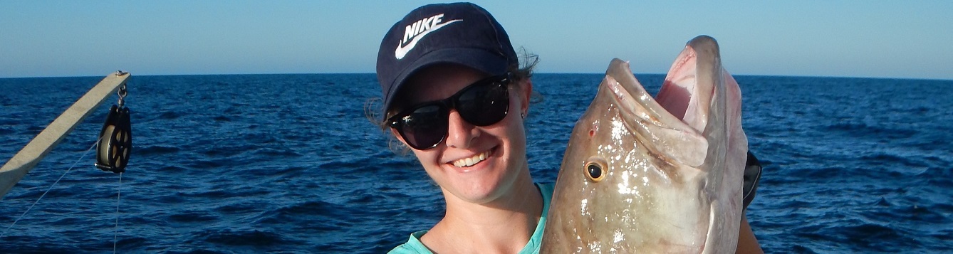 NCBS intern Courtney S holding a grouper on a FIM offshore trip