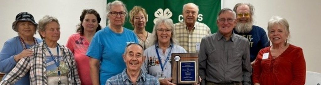 people smiling after receiving an award