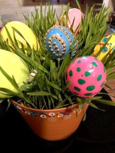 colored plastic Easter eggs placed in wheat grass