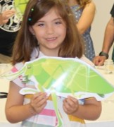 child holding oversized laminated insect