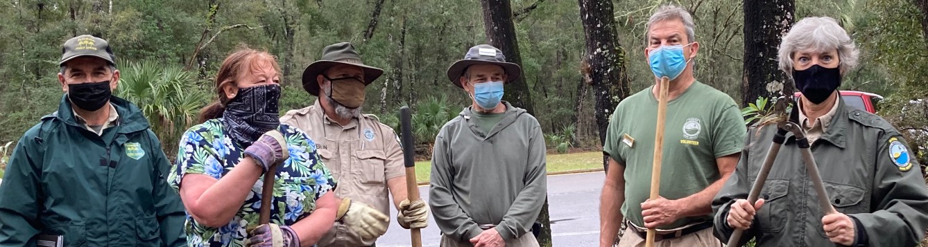 masked people with shovels and loppers