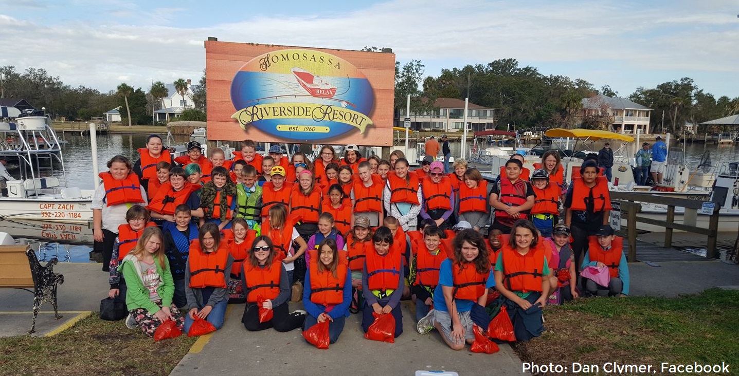 a group of kids wearing life jackets