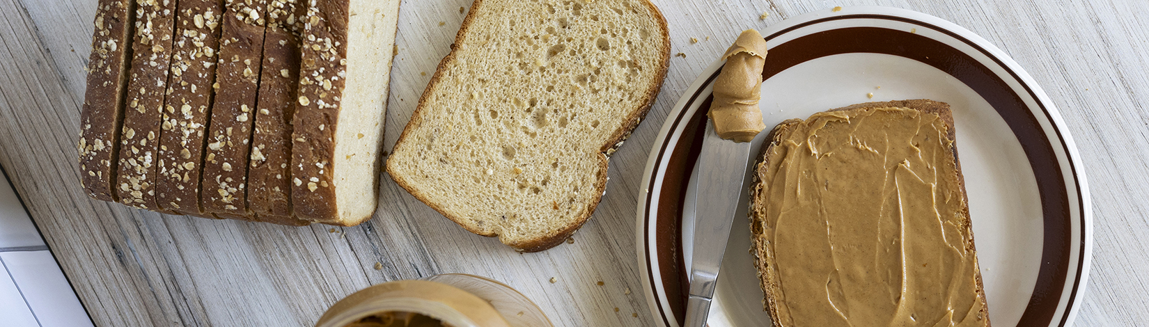 Peanut butter spread on sliced bread.