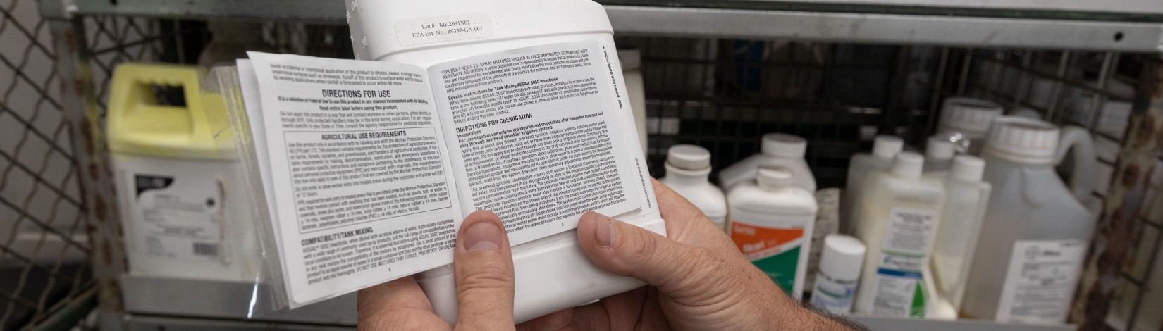 Reading the safety and instruction labels of agriculture-based pesticides and fertilizers.
