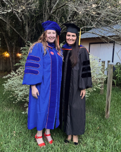 Dr. Lisa Emerson in her graduation regalia with her mentor Dr. Mariola Ferraro. Photo credit: Christopher Ferraro. 