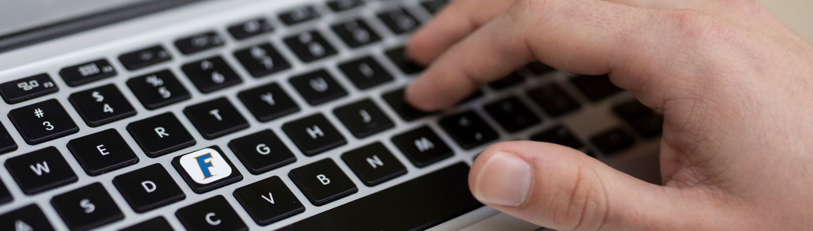 Hand on a computer keyboard.