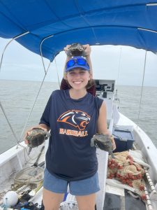 Intern Lily Frierson holding 2 Diamondback terrapins (Malaclemys terrapin), with a third proving that terrapins do not enjoy being in FIM nets.