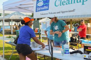 A volunteer at the check-in table grabing supplies. 