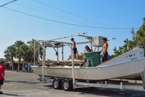 Local watermen using a clam boat to bring in large debris from surrounding islands. 