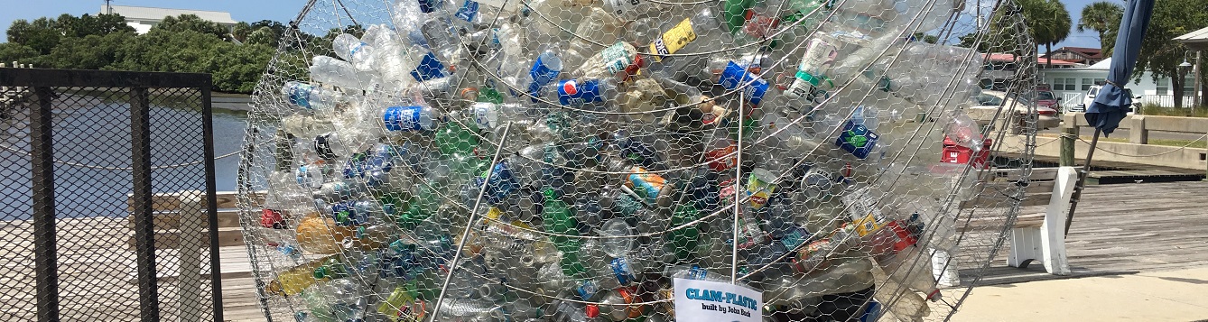 plastic bottles fill a metal clam sculpture