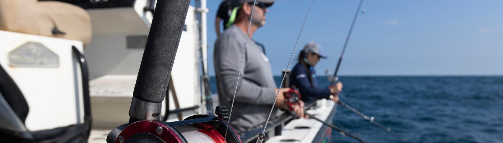 Reeling in fishing line on a fishing poll.